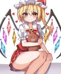  1girl absurdres ascot blonde_hair blush closed_mouth collared_shirt crystal feet_out_of_frame flandre_scarlet hair_between_eyes hat heart highres holding holding_stuffed_toy kiui_(dagk8254) light_smile looking_at_viewer medium_hair miniskirt mob_cap multicolored_wings one_side_up pleated_skirt puffy_short_sleeves puffy_sleeves red_eyes red_skirt red_vest shirt short_sleeves simple_background skirt solo stuffed_animal stuffed_toy teddy_bear touhou vest white_background white_headwear white_shirt wings yellow_ascot 
