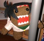  bandana black_hair cosplay domo-kun domon_kasshu domon_kasshu_(cosplay) fusion g_gundam gundam lowres nippon_housou_kyoukai pun stuffed_animal stuffed_toy 