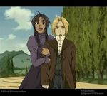  1boy 1girl ahoge arm_hug blonde_hair braid brown_eyes brown_hair coat conqueror_of_shambala dark_skin dress edward_elric fullmetal_alchemist fullmetal_alchemist:_conqueror_of_shamballa high_collar long_hair noah_(fma) open_mouth outdoors ponytail purple_dress smile sweatdrop vest yellow_eyes 