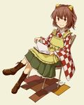  book book_on_lap boots brown_hair chair chair_tipping character_name checkered clothes_writing crossed_legs full_body hair_bobbles hair_ornament kawashina_(momen_silicon) looking_at_viewer motoori_kosuzu open_book red_eyes short_hair sitting smile solo touhou 