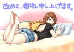  back barefoot bed book brown_eyes brown_hair hanamura legs looking_back lying on_stomach original pillow short_hair shorts smile solo 