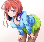  1girl bent_over black_pantyhose blue_cardigan blue_eyes breasts brown_hair cardigan cleavage closed_mouth commentary dulldull go-toubun_no_hanayome green_skirt hands_on_own_thighs headphones headphones_around_neck highres large_breasts light_blush long_hair long_hair_between_eyes long_sleeves looking_at_viewer miniskirt nakano_miku pantyhose pleated_skirt school_uniform simple_background skirt solo 
