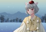  1girl alternate_costume animal_ear_fluff bare_tree closed_mouth commentary_request grey_hair hat inubashiri_momiji japanese_clothes kimono kyabekko looking_at_viewer outdoors pom_pom_(clothes) red_eyes red_headwear short_hair snow snowing solo tokin_hat touhou tree upper_body yellow_kimono 