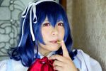  1girl asian blue_hair chouzuki_maryou cosplay fat photo plump pocky red_eyes seikon_no_qwaser solo yamanobe_tomo yamanobe_tomo_(cosplay) 