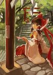  architecture ascot bow brown_eyes brown_hair day detached_sleeves east_asian_architecture grass hair_bow hair_tubes hakurei_reimu head_tilt highres hokora_(shrine) ikomochi looking_at_viewer looking_back ofuda outdoors path road rock shide short_hair sitting skirt skirt_set solo stairs torii touhou tree 