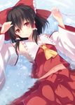  armpits ascot bad_id bad_pixiv_id black_hair bow detached_sleeves hair_bow hair_tubes hakurei_reimu long_sleeves looking_at_viewer marotti midriff navel red_eyes red_string shirt skirt skirt_set solo string touhou water wide_sleeves 