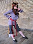  animal_ears brown_hair cosplay finger_to_mouth hand_on_hip holo long_hair no_socks photo solo spice_and_wolf tail wolf_ears 
