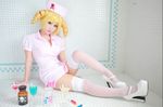  1girl catherine catherine_(game) chair cosplay drill_hair drink hat high_heels lipstick makeup nurse nurse_cap nurse_uniform photo thighhighs 