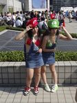  2girls absurdres comiket comiket82 cosplay highres luigi luigi_(cosplay) mario mario_(cosplay) mario_(series) multiple_girls nintendo photo real_life super_mario_bros. 