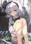  1girl absurdres bare_legs black_hairband blush bob_cut bow bowtie breasts collared_shirt commentary_request dfra feet_out_of_frame ghost green_eyes green_skirt green_vest hair_bow hairband highres hitodama_print hugging_own_legs indoors knees_up konpaku_youmu konpaku_youmu_(ghost) legs light_particles looking_at_viewer scabbard sheath shirt short_hair sitting skirt skirt_set solo sword touhou vest weapon white_hair white_shirt window 