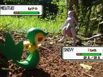  grass health_bar mewtwo nintendo no_humans outdoors photo photoshop plant pokemon pokemon_battle red_eyes snivy toy venus_symbol 