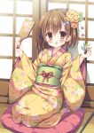  1girl :d bangs blush brown_eyes brown_flower brown_hair commentary_request cushion eyebrows_visible_through_hair fingernails floral_print flower hagoita hair_between_eyes hair_flower hair_ornament hands_up hanetsuki highres holding_paddle japanese_clothes kimono kouta. long_hair long_sleeves looking_at_viewer obi open_mouth original paddle print_kimono sash seiza sitting smile socks solo white_legwear wide_sleeves yellow_flower yellow_kimono zabuton 