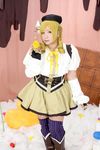  1girl asian blonde_hair breasts brown_eyes chouzuki_maryou cosplay drill_hair fingerless_gloves gloves hat large_breasts mahou_shoujo_madoka_magica photo plump solo soul_gem tomoe_mami tomoe_mami_(cosplay) twin_drills 