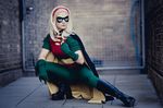  1girl aigue_marine batman_(series) blonde_hair cape cosplay crouch dc_comics hairband mask photo robin_(dc) solo squatting stephanie_brown 