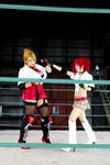  arena blonde_hair boxing_ring breasts candy_cane_(rumble_roses) candy_cane_(rumble_roses)_(cosplay) chouzuki_maryou cleavage cosplay fingerless_gloves gloves large_breasts miss_spencer miss_spencer_(cosplay) multiple_girls photo red_hair rumble_roses rumble_roses_xx suzuka_itsuki 