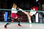  arena blonde_hair boxing_ring breasts candy_cane_(rumble_roses) candy_cane_(rumble_roses)_(cosplay) chouzuki_maryou cleavage cosplay fingerless_gloves gloves large_breasts miss_spencer miss_spencer_(cosplay) multiple_girls photo red_hair rumble_roses rumble_roses_xx suzuka_itsuki 