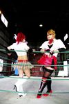  arena blonde_hair boxing_ring breasts candy_cane_(rumble_roses) candy_cane_(rumble_roses)_(cosplay) chouzuki_maryou cleavage cosplay fingerless_gloves glasses gloves large_breasts miss_spencer miss_spencer_(cosplay) multiple_girls photo red_hair rumble_roses rumble_roses_xx suzuka_itsuki 