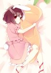  animal_ears bad_id bad_pixiv_id bandaid bandaid_on_knee blush bunny_ears bunny_tail carrot dress from_side highres inaba_tewi lying mafuyu_(chibi21) on_bed on_side pillow pillow_hug pink_dress red_eyes ribbon solo tail touhou 