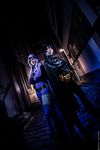  2girls alley back-to-back batgirl batman_(series) belt black_hair blonde_hair breathless-ness cape cassandra_cain cosplay crossed_arms dc_comics hood multiple_girls photo sheree_chuang spoiler_(dc) standing stephanie_brown 