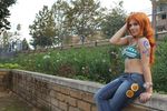  1girl bikini bikini_top breasts cosplay denim jeans large_breasts nami nami_(cosplay) nami_(one_piece) nami_(one_piece)_(cosplay) nice one_piece orange_hair pants photo sexy sitting solo swimsuit wall 