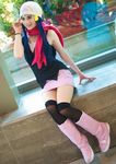  1girl beanie boots cosplay hat hikari_(pokemon) photo pink_shoes pink_skirt pokemon scarf sitting smile 
