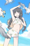  1girl absurdres arm_up armpits beach bikini bird black_hair blue_archive blue_sky blurry blurry_background braid cloud day ggaebchun halo hat hat_on_back highres leaf leaf_on_head leaf_print long_hair miyu_(blue_archive) miyu_(swimsuit)_(blue_archive) ocean outdoors red_eyes seagull sky solo swimsuit tears twin_braids 