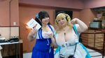  2girls asian blonde_hair breasts brown_eyes cleavage cosplay fat headphones hoshima_mika huge_breasts jewelry multiple_girls necklace nitroplus photo star super_pochaco super_pochaco_(cosplay) twintails 