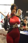  1girl armor belt black_hair bodysuit cosplay dark_eyes erect_nipples long_hair looking_at_viewer nipples photo ponytail soul_calibur spandex sword taki_(soulcalibur) weapon 