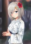  blue_eyes blurry blush depth_of_field eyes_visible_through_hair fingers_together flower hair_flower hair_ornament hair_over_one_eye hairclip hamakaze_(kantai_collection) hands_together highres japanese_clothes kantai_collection kimono light_smile looking_at_viewer obi sash shokora_momiji silver_hair smile solo 