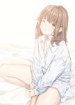  1girl bangs bed_sheet brown_hair closed_mouth collared_shirt dress_shirt eyebrows_visible_through_hair fangxiang_cuoluan happy_new_year highres long_sleeves looking_at_viewer new_year one_eye_closed original shirt sitting thighs waking_up white_shirt yellow_eyes 