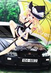  :d blonde_hair bottomless breasts brown_eyes car character_name cleavage detached_sleeves fang ground_vehicle hat holding holding_umbrella kirisame_marisa large_breasts long_hair looking_at_viewer motor_vehicle nissan nissan_skyline open_mouth race_queen smile solo thigh_strap touhou umbrella witch_hat yaki_mayu 