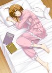  ahoge barefoot bed book brown_hair copyright_request feet inue_shinsuke lying pajamas short_hair solo 