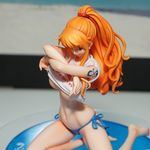  1girl breasts female figure large_breasts nami_(one_piece) one_piece orange_hair photo solo underboob undressing 