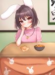  1girl animal_ears animal_print black_hair blush bowl breasts brown_eyes carrot_necklace closed_mouth commentary_request floppy_ears food fruit hand_on_own_cheek hand_on_own_face hanging_scroll head_tilt highres inaba_tewi jewelry kasoka_soka kotatsu looking_at_viewer mandarin_orange medium_bangs medium_breasts necklace rabbit_ears rabbit_girl rabbit_print scroll short_hair sitting smile solo table touhou 