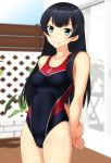  1girl absurdres agano_(kantai_collection) anchor_print black_hair black_swimsuit blue_eyes breasts competition_swimsuit covered_navel cowboy_shot fence highleg highleg_swimsuit highres kantai_collection long_hair multicolored multicolored_clothes multicolored_swimsuit one-piece_swimsuit red_swimsuit small_breasts solo standing swimsuit takafumi 