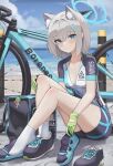  1girl absurdres animal_ear_fluff animal_ears beach bicycle bike_jersey bike_shorts blue_archive blue_eyes blue_shorts blue_sky blue_sleeves blush breasts cross_hair_ornament cycling_uniform dolri extra_ears gloves green_gloves grey_hair hair_ornament halo highres looking_at_viewer medium_breasts medium_hair shiroko_(blue_archive) shiroko_(cycling)_(blue_archive) shirt shoes shore short_sleeves shorts sidelocks sitting sky sneakers socks solo white_shirt wolf_ears 