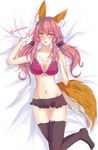  animal_ears bed black_legwear blush bra breasts cleavage fate/extra fate_(series) fox_ears fox_tail groin hand_on_own_chest highres large_breasts looking_at_viewer lying midriff navel open_mouth pink_bra pink_hair solo tail tamamo_(fate)_(all) tamamo_no_mae_(fate) tanaji twintails twitter_username underwear yellow_eyes 