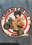  abazu-red bikini_top black_hair breasts downscaled girls_und_panzer green_eyes ground_vehicle highres hoshino_(girls_und_panzer) jumpsuit large_breasts md5_mismatch motor_vehicle motorcycle nose_art resized riding solo twitter_username 