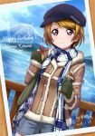  1girl artist_name bangs birthday blonde_hair bottle box character_name commentary_request copyright_name dated day english_text eyebrows_visible_through_hair gift gift_box gloves happy_birthday hat highres holding jacket koizumi_hanayo long_sleeves love_live! love_live!_school_idol_project mount_fuji ocean photo_(object) purple_eyes scarf short_hair short_shorts shorts solo xiaoxin041590 