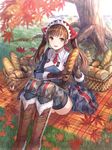  alicia_melchiott baguette black_gloves blue_legwear bread brown_eyes brown_hair food fuji_choko gloves grass leaf long_hair looking_at_viewer outdoors senjou_no_valkyria senjou_no_valkyria_1 sitting solo thighhighs tree twintails watermark 