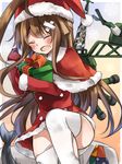  ahoge alternate_costume bandaid blush box brown_hair buttons capelet closed_eyes commentary_request dress fang gift gift_box gloves hair_between_eyes hat huge_ahoge kantai_collection kuma_(kantai_collection) kyusai_kuma leg_lift long_hair machinery open_mouth red_dress red_gloves santa_costume santa_hat sitting solo thighs tongue white_legwear 