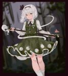  1girl black_bow black_bowtie black_hairband black_ribbon blurry blurry_background bob_cut border bow bowtie closed_mouth collared_shirt feet_out_of_frame flower frilled_skirt frills green_eyes green_skirt green_vest hair_ribbon hairband hand_on_hilt highres hitodama_print ichita_(yixisama-shihaohaizhi) konpaku_youmu konpaku_youmu_(ghost) long_sleeves looking_at_viewer outside_border pink_flower red_border ribbon scabbard sheath sheathed shirt shirt_tucked_in short_hair signature skirt skirt_set socks solo sword sword_on_back touhou vest weapon weapon_on_back white_hair white_shirt white_socks 