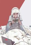  absurdres altera_(fate) alternate_costume blanket candy candy_wrapper commentary_request computer dark_skin fate/extella fate/extra fate/grand_order fate_(series) food grey_shirt headphones headphones_around_neck highres holding laptop md5_mismatch pillow playing_games red_eyes reroi shirt sitting solo sweat two-tone_background under_covers veil white_hair 