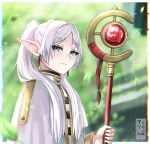  1girl blush capelet commentary_request dangle_earrings earrings elf frieren green_eyes highres holding holding_staff jewelry leaf long_hair long_sleeves looking_at_viewer muhammaddeny outdoors parted_bangs pointy_ears shirt solo sousou_no_frieren staff striped striped_shirt twintails white_capelet white_hair 