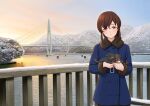  1girl blue_coat braid bridge brown_hair coat commentary_request cowboy_shot dog fur-trimmed_coat fur_trim hitakikan kantai_collection long_hair looking_at_viewer mountain orange_eyes outdoors puppy railing river single_braid smile souya_(kancolle) 