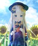  abigail_williams_(fate/grand_order) bangs black_bow black_dress black_hat blonde_hair blue_eyes blue_sky blush bow commentary_request crossed_bandaids dress fate/grand_order fate_(series) field flower flower_field forehead hair_bow hat highres holding holding_stuffed_animal long_hair long_sleeves looking_at_viewer object_hug open_mouth orange_bow parted_bangs polka_dot polka_dot_bow sakazakinchan sky sleeves_past_fingers sleeves_past_wrists solo stuffed_animal stuffed_toy sunflower sunlight teddy_bear 