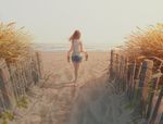  artist_name barefoot beach brown_hair commentary day denim denim_shorts fence footprints from_behind holding long_hair original outdoors plant revision sandals shirt shorts signature silhouette solo striped striped_shirt tamaki_(tamaki_illust) walking water wind wooden_fence 