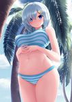  bikini blue_eyes blush breasts cowboy_shot eyes_visible_through_hair from_below hair_ornament hair_over_one_eye hairclip hamakaze_(kantai_collection) highres kantai_collection large_breasts looking_at_viewer navel nicoby palm_tree parted_lips short_hair silver_hair solo stomach striped striped_bikini swimsuit thighs tree 
