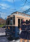  black_hair blurry bow cable car city cowboy_shot day depth_of_field finanl ground_vehicle hair_bow highres motor_vehicle multiple_girls original outdoors ponytail power_lines road school_uniform sky street streetcar tree 