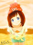  1girl arms_behind_back artist_signature blue_eyes breasts brown_hair cleavage downblouse hat leaning_forward logic_ils looking_at_viewer medium_breasts mizuki_(pokemon_sm) nintendo no_bra pokemon pokemon_(game) pokemon_sm short_hair shorts smile solo water 